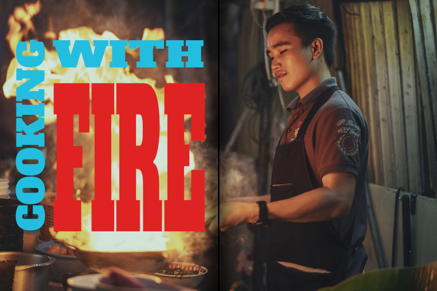 EDITORIAL DPS PHOTO OF MAN COOKING ON WOK WITH FIRE
