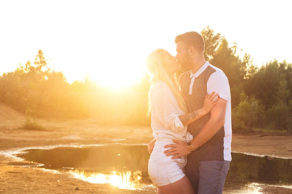 A sunset portrait that embraces lens flare creates a romantic vibe
