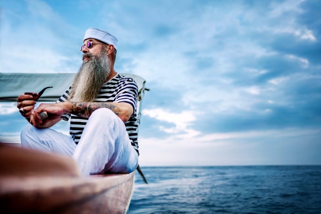 Editorial photo of a sailor on a small boat at sea