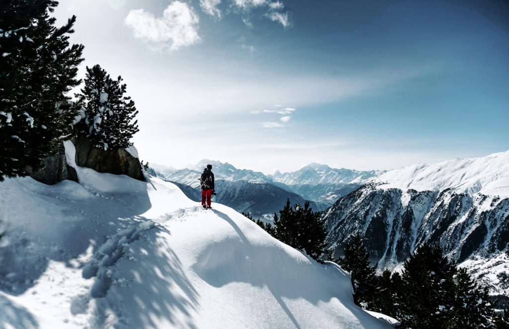 A man alone in a snowy mountain landscape